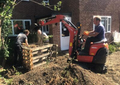 A garden that's being dug out using a mini digger and driver hire service