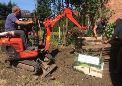 A garden that's being dug out using a mini digger and driver hire service