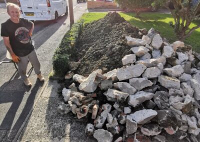 A pile of rubbish that's been dug out using a mini digger and driver hire service, ready to be collected by a grab lorry