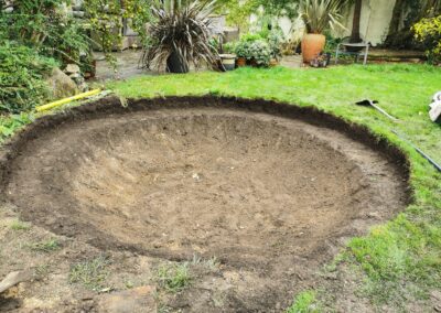 A hole for a sunken trampoline being dug out using a mini digger and driver hire service