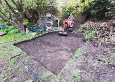 A patio area being dug out using a mini digger and driver hire service