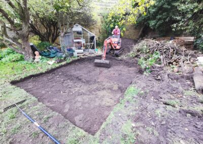 A paving area being dug out using a mini digger and driver hire service