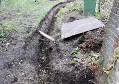 A trench for cables being dug out using a mini digger and driver hire service