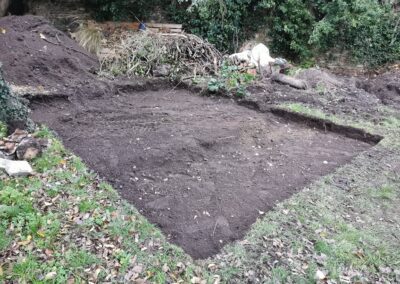 A patio area being dug out using a mini digger and driver hire service