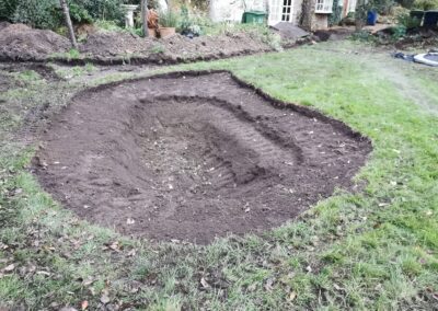 A multi-level pond being dug out using a mini digger and driver hire service